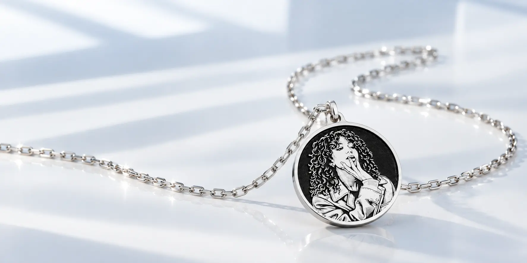 Personalized sterling silver photo pendant on white fabric