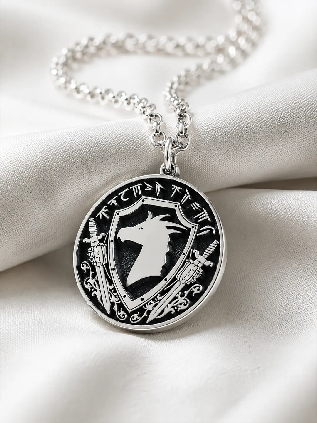 Custom sterling silver family crest pendant on ivory fabric